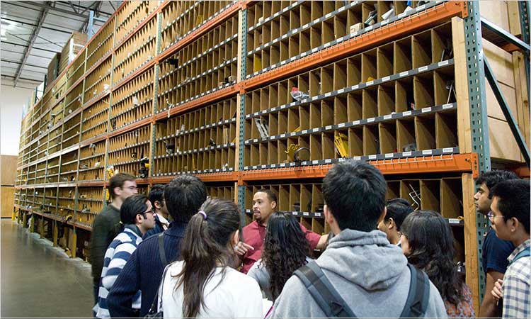 Supply Chain Engineering masters students inside a warehouse