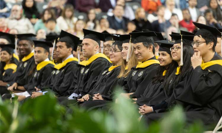 Students at a Georgia Tech graduation ceremony sitting in audience