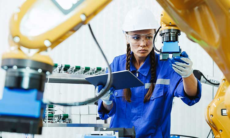 Female student in field examining production process