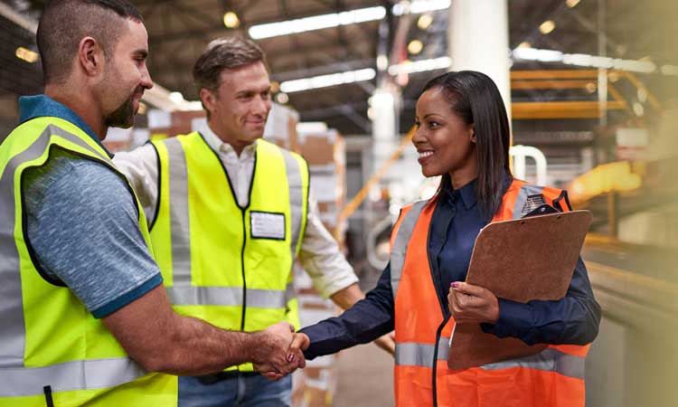 Engineers meeting in a warehouse